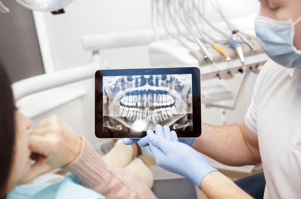 teeth x-rays patient using a digital tablet technology